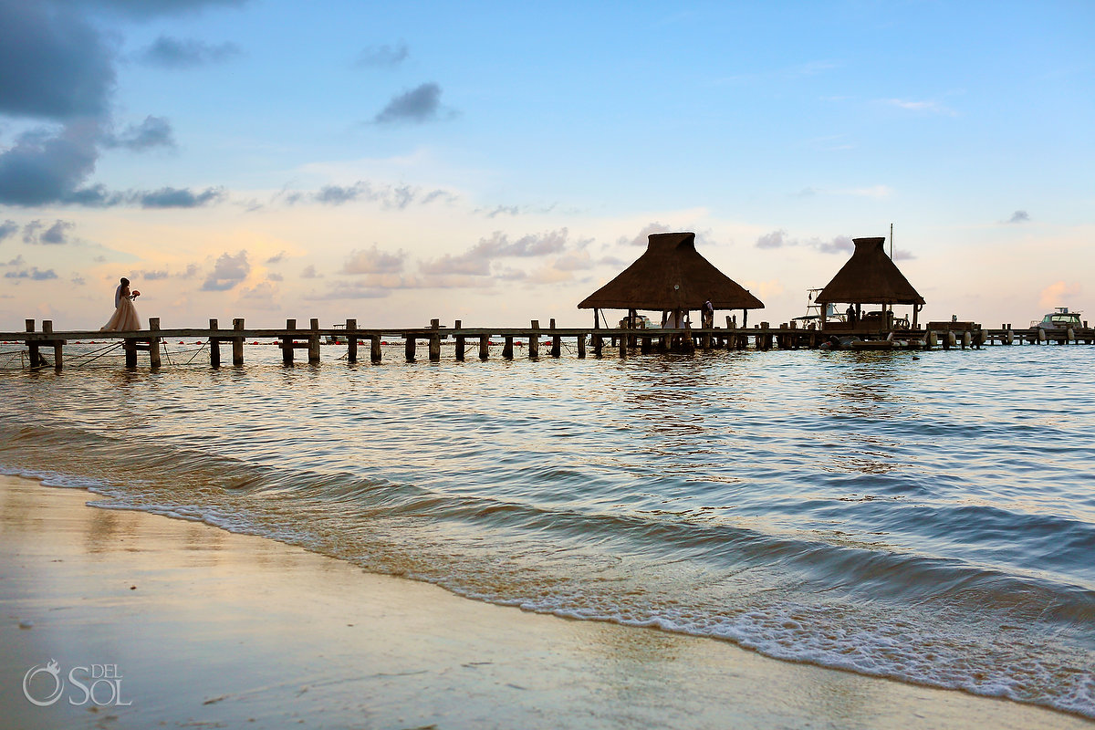 bride and groom walking on the Pier at Zoetry Paraiso La Bonita boutique all inclusive hotel